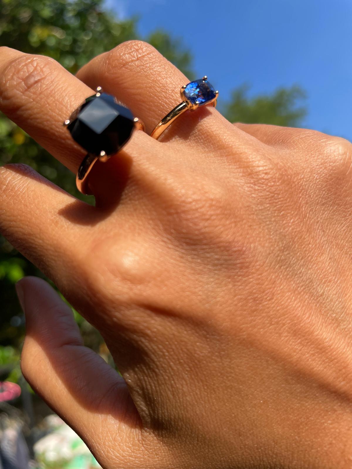 Finished sapphire rings worn outdoors in sunlight.
