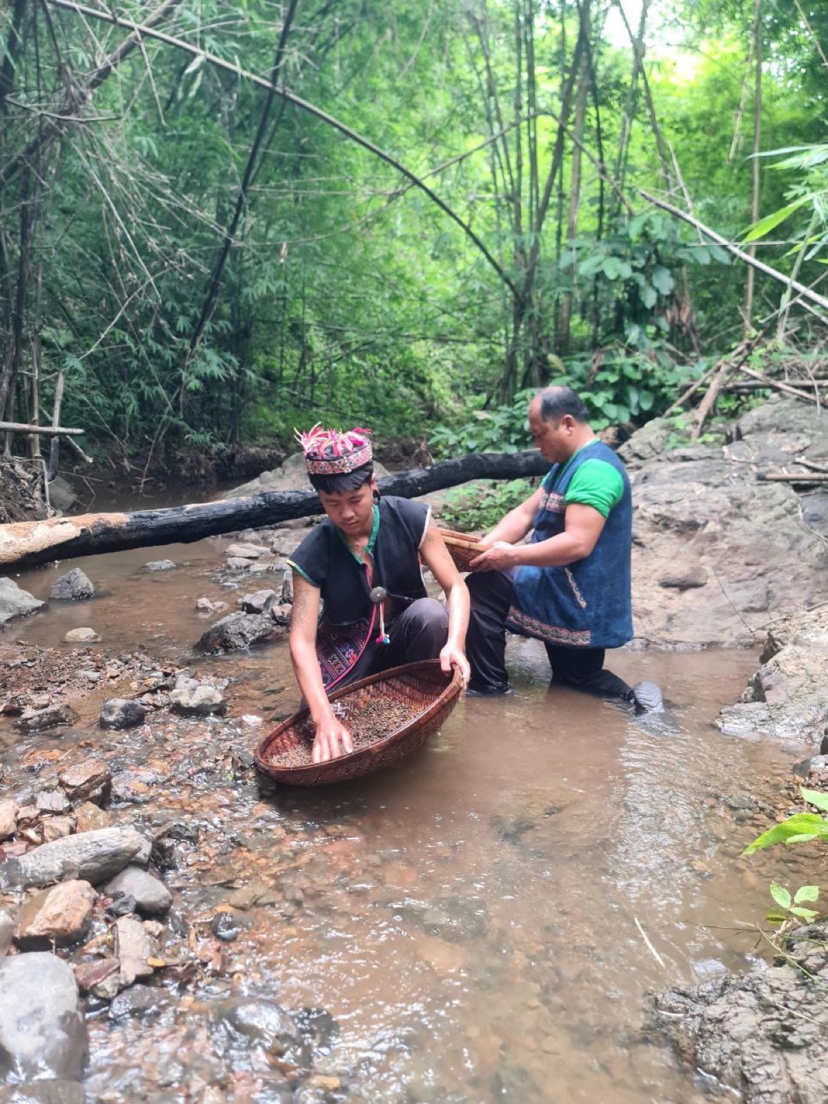 Gemstone panners working river gravel in a Northern Thai jungle stream.