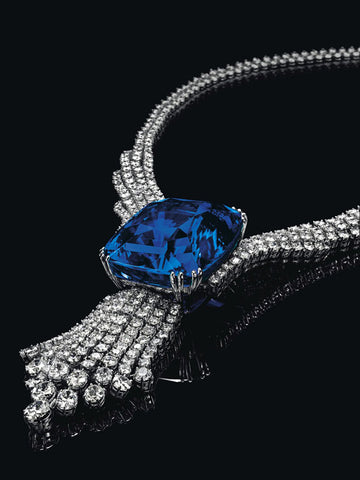 The Blue Belle of Asia sapphire necklace on a dark background.